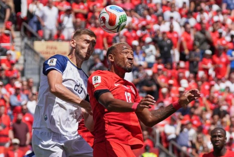 Canada's Derek Cornelius, right vies for the ball with Bosnia's Jovo Lukic during the World Cup Group B soccer match between Canada and Bosnia in Toronto, Friday, June 12, 2026. (AP Photo/Stephanie Scarbrough)